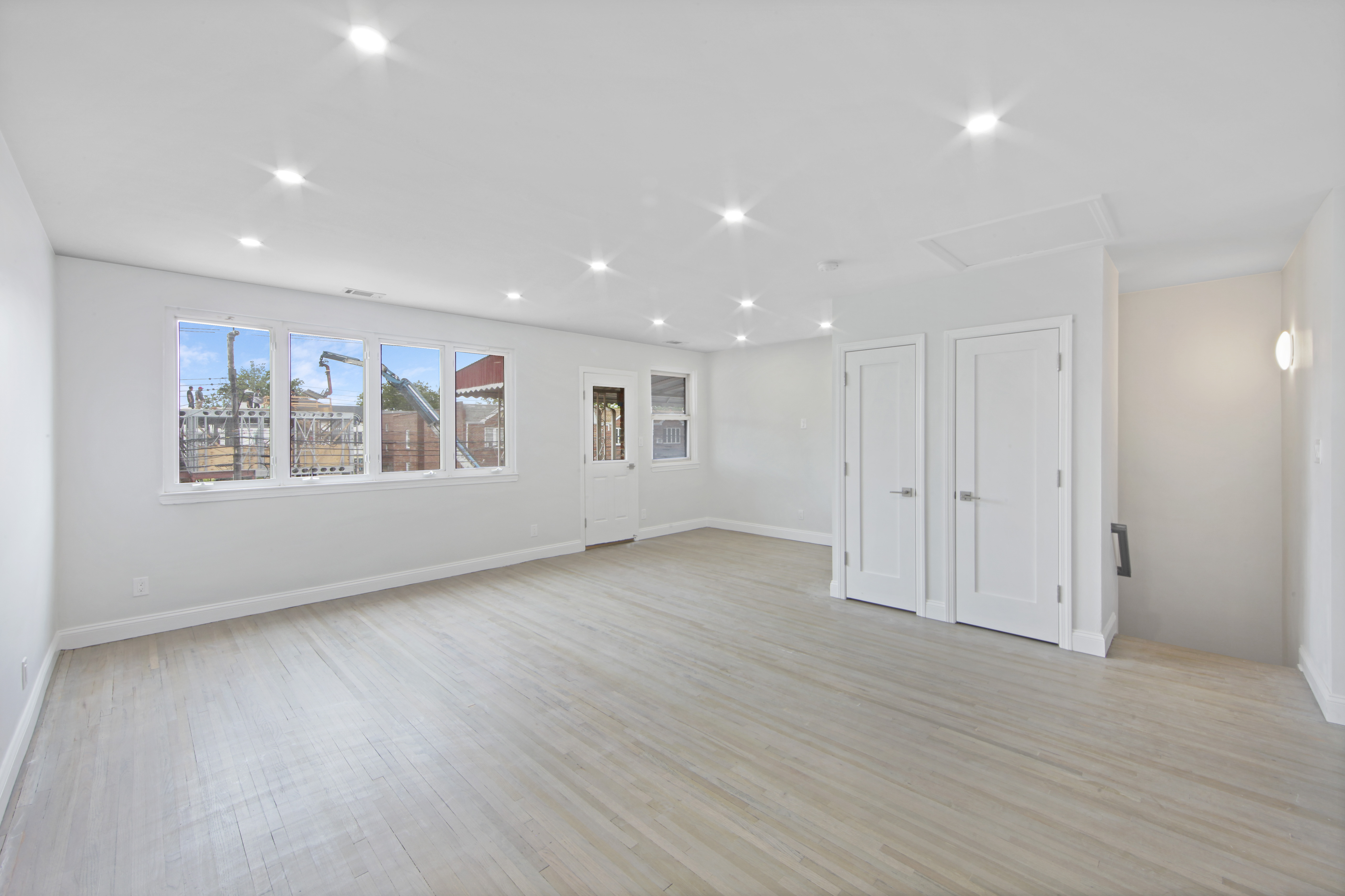 2345 East 1st Street, Unit 2 Brooklyn, NY 11223 - Photo 3 of 10 a view of an empty room with a window and wooden floor