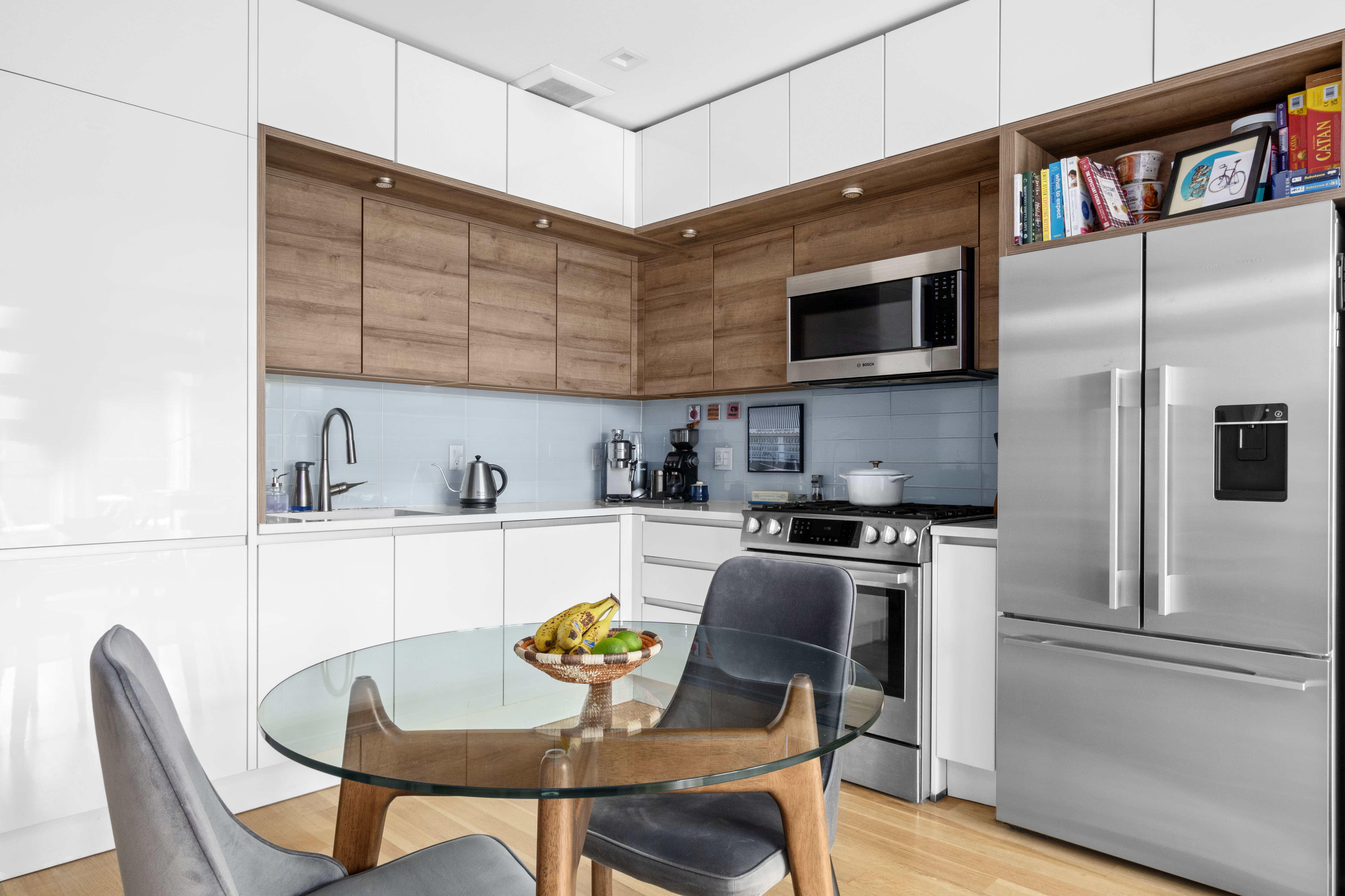 203 Quincy Street, Unit 4B Brooklyn, NY 11216 - Photo 3 of 11 a kitchen with stainless steel appliances granite countertop a stove top oven a sink a table and chairs