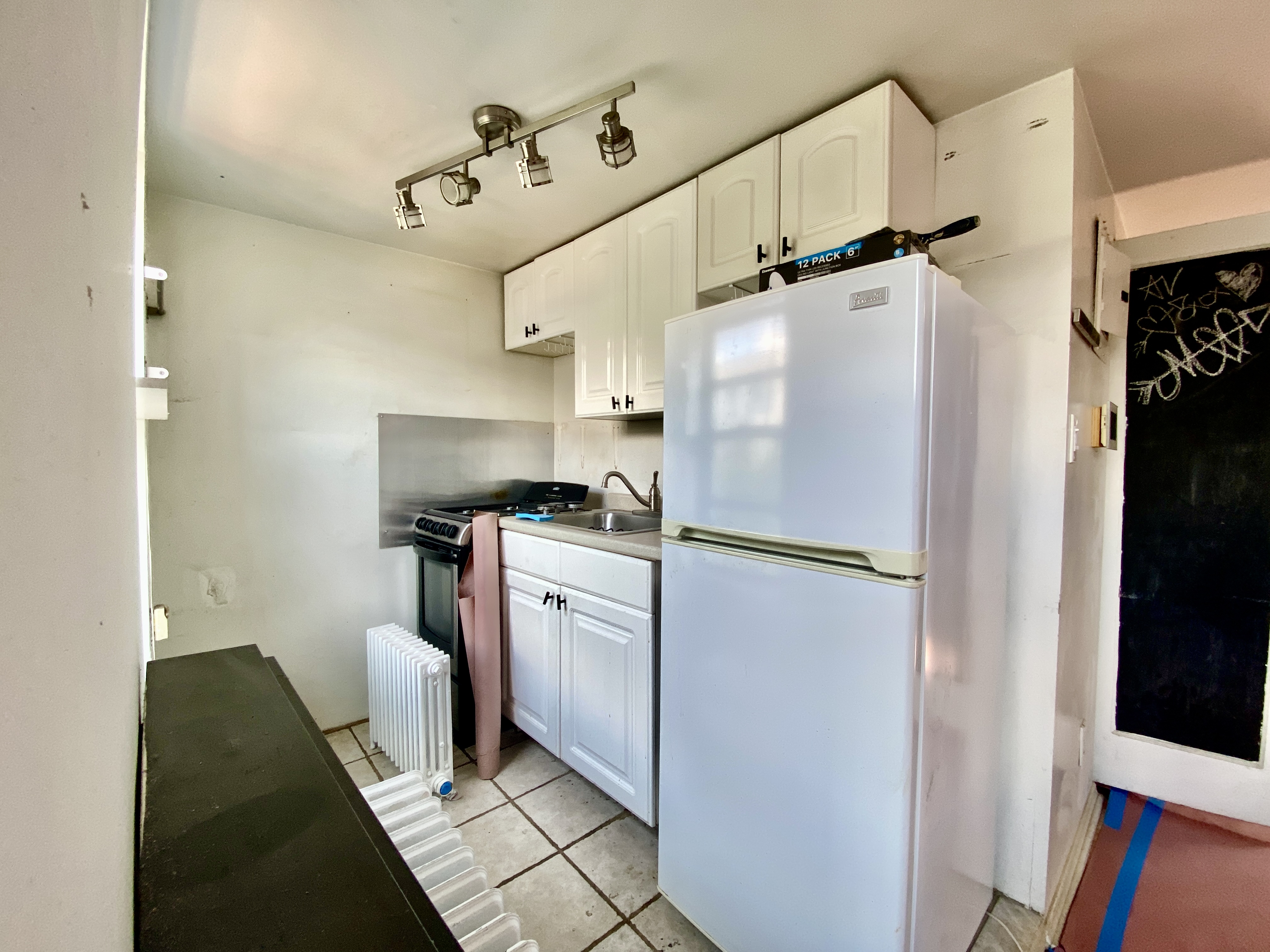 140 Washington Avenue, Unit 4 Brooklyn, NY 11205 - Photo 6 of 8 a kitchen with cabinets and refrigerator