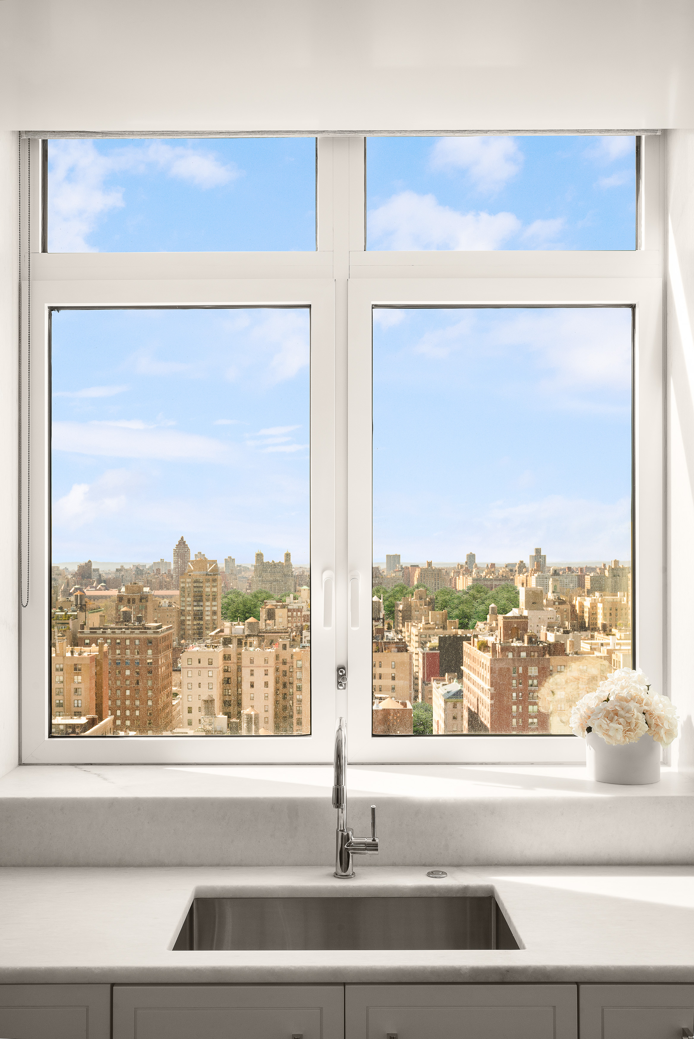200 East 83rd Street, Unit 24C Manhattan, NY 10028 - Photo 8 of 35 a view of a living room and a floor to ceiling window