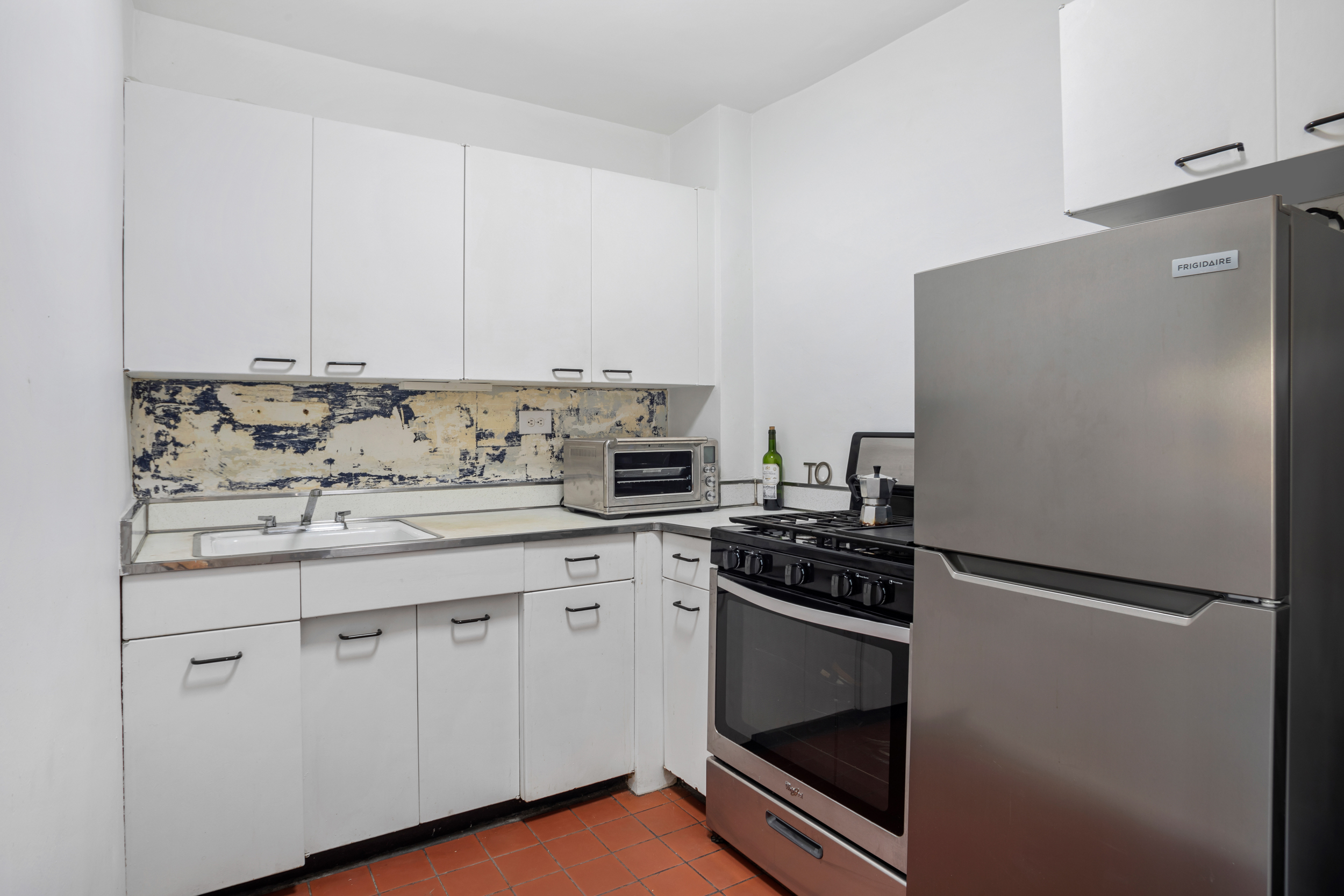 230 East 15th Street, Unit 6C Manhattan, NY 10003 - Photo 5 of 9 a kitchen with appliances a sink and cabinets