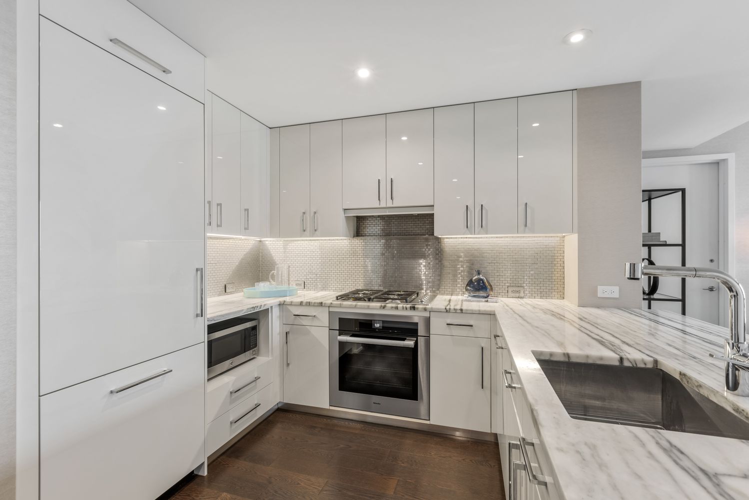 a kitchen with granite countertop white cabinets and white appliances