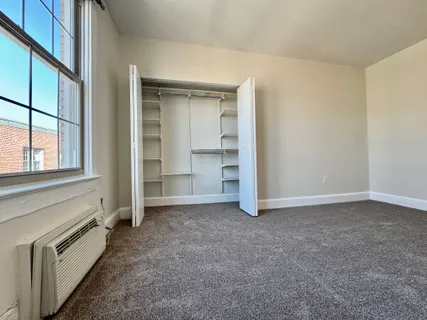 an empty room with a empty space and windows