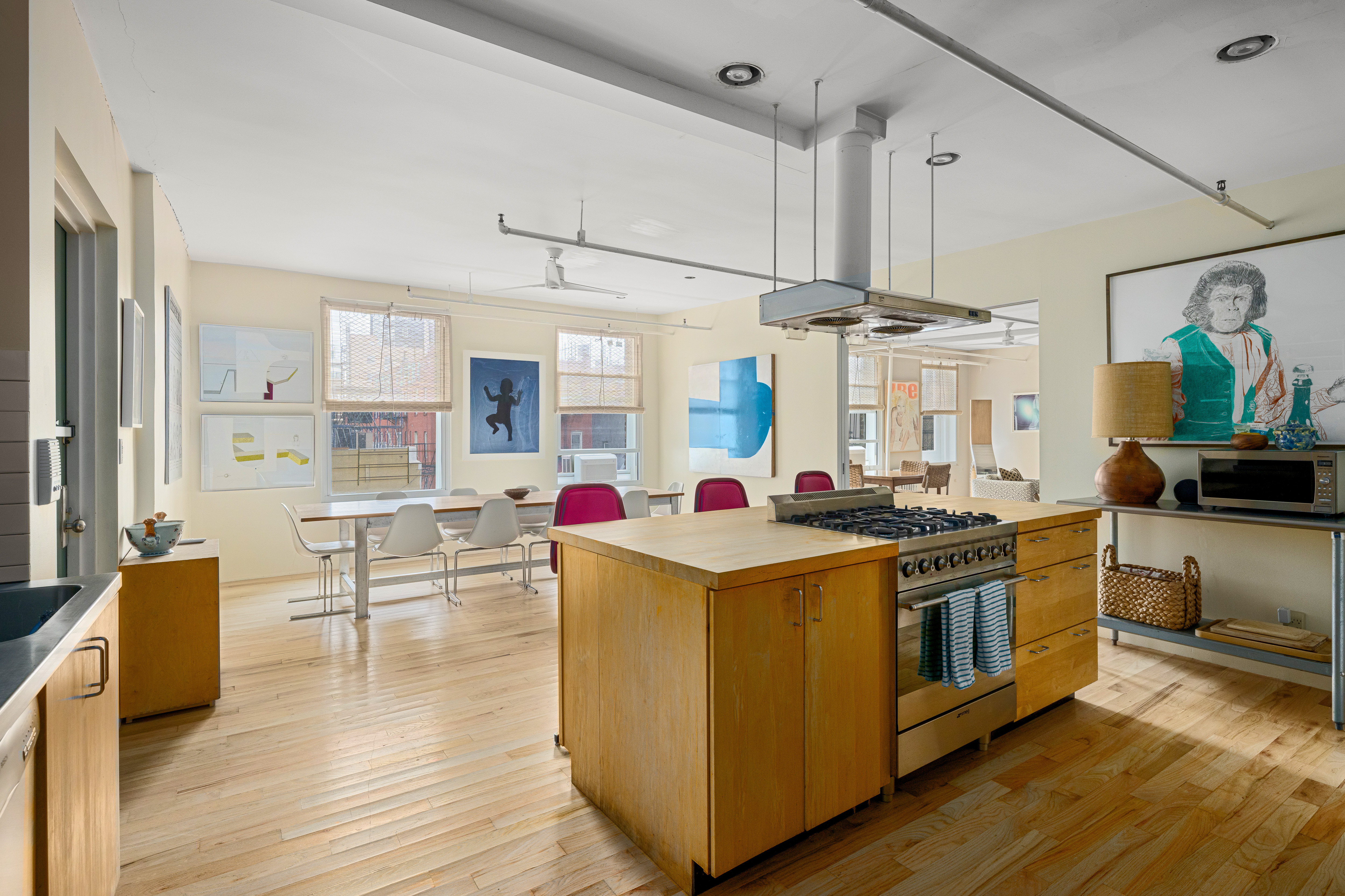 191 Chrystie Street, Unit 5R Manhattan, NY 10002 - Photo 3 of 16 a kitchen with stainless steel appliances a stove and wooden floor