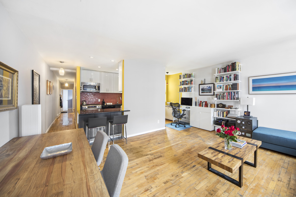 319 East 105th Street, Unit 5A Manhattan, NY 10029 - Photo 3 of 13 a living room with furniture a rug and gym equipment with wooden floor
