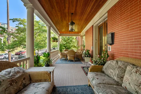 a living room with patio furniture and a large window