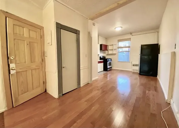 a view of a kitchen with a refrigerator and a stove