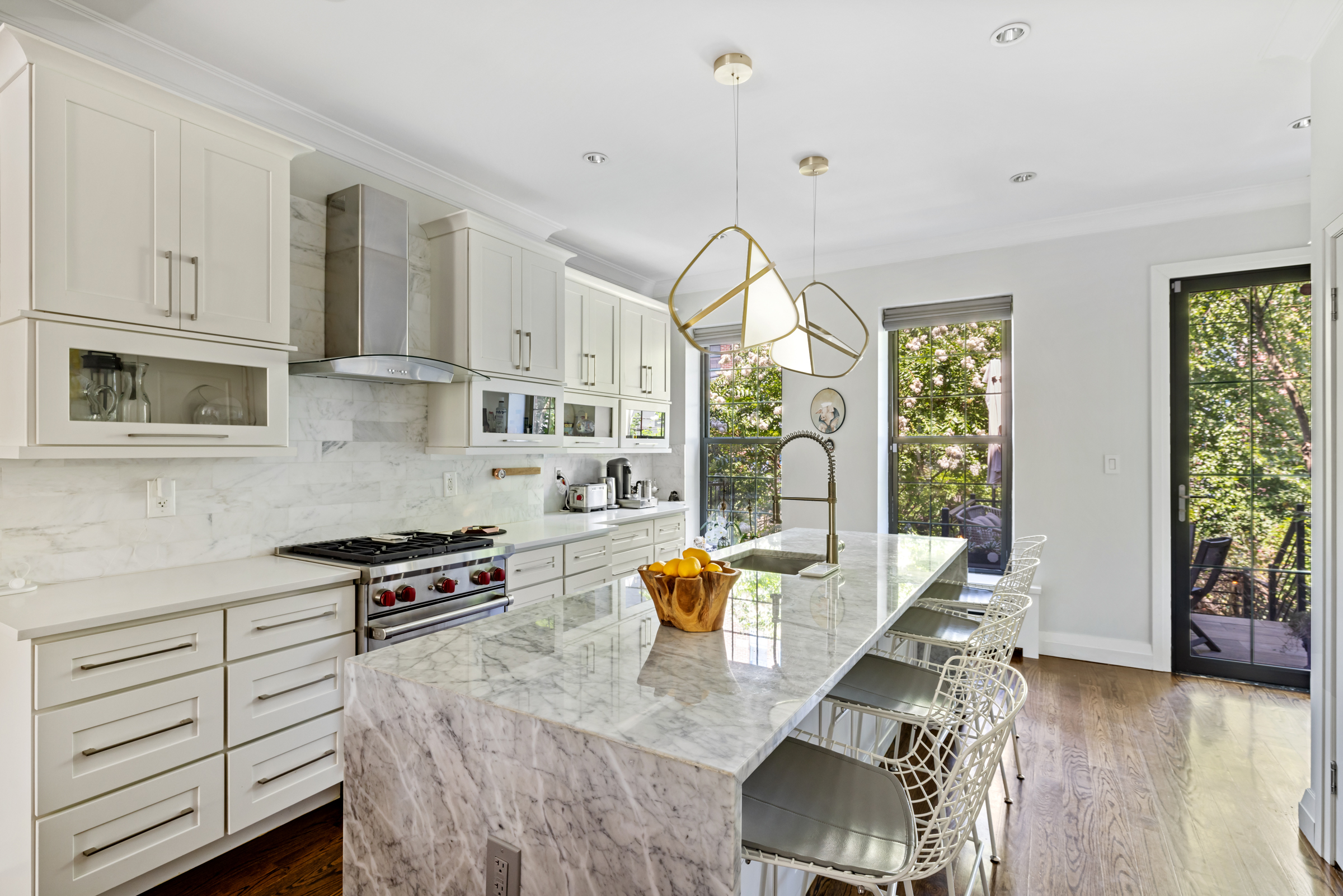 439 A Monroe Street Brooklyn, NY 11221 - Photo 5 of 29 a kitchen with stainless steel appliances granite countertop a stove and white cabinets with wooden floor