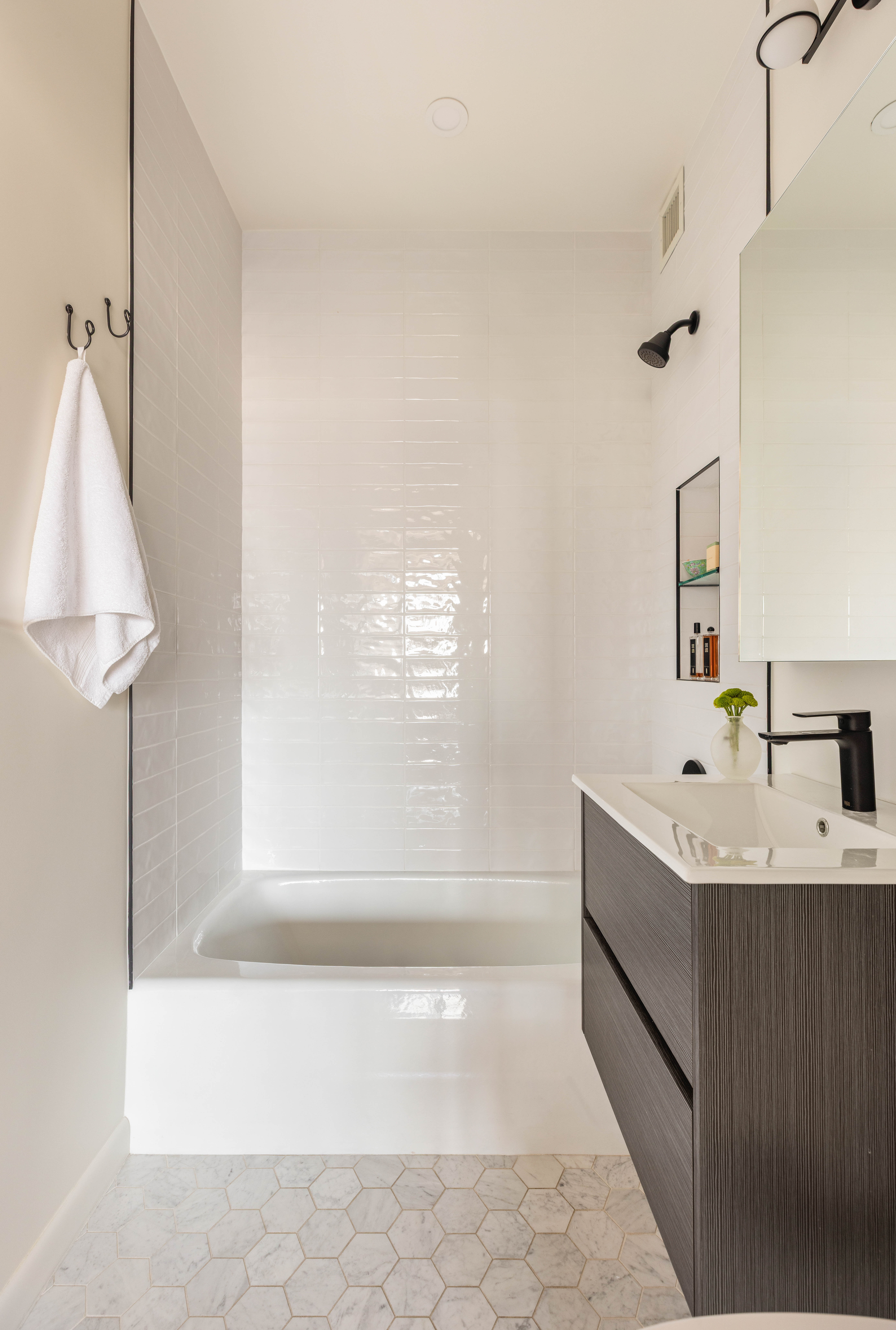 60 East 8th Street, Unit 30F Manhattan, NY 10003 - Photo 8 of 11 a bathroom with a bathtub a sink and a window