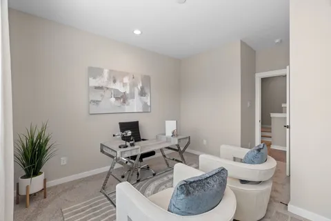 a work room with furniture and a potted plant