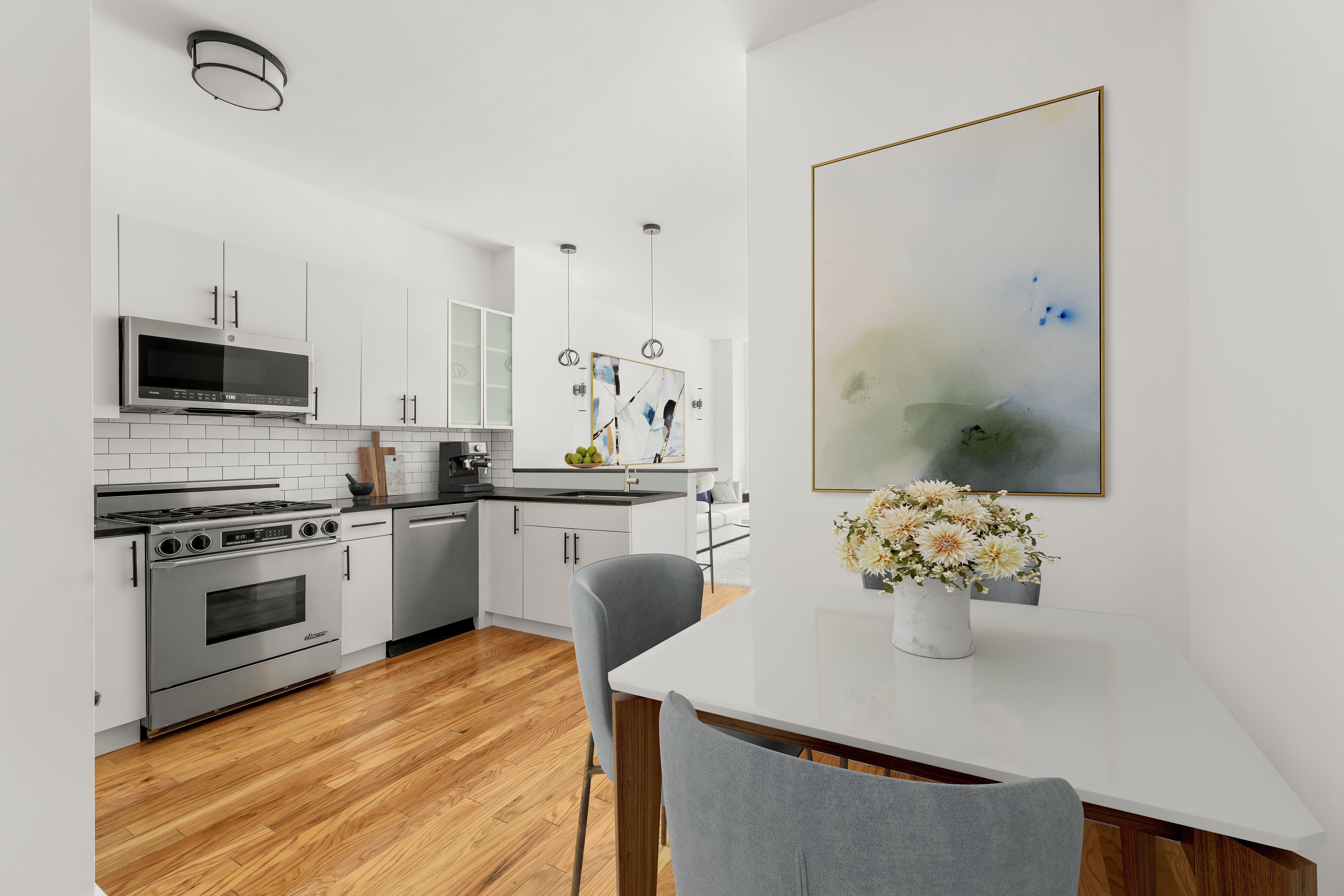 212 East 57th Street, Unit 3B Manhattan, NY 10022 - Photo 13 of 17 a kitchen with stainless steel appliances kitchen island granite countertop a stove a sink and a refrigerator
