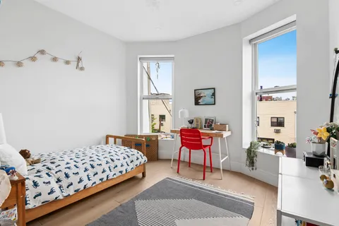 a bedroom with bed and a window
