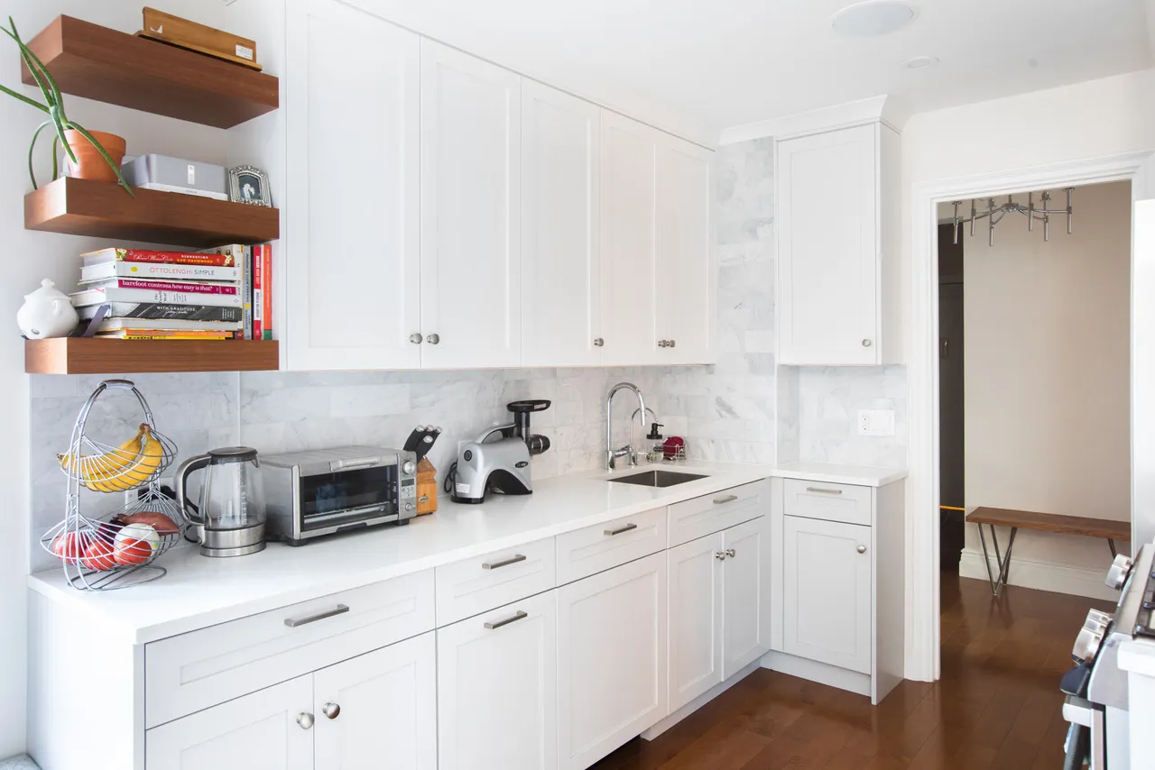a kitchen with stainless steel appliances white cabinets and a stove
