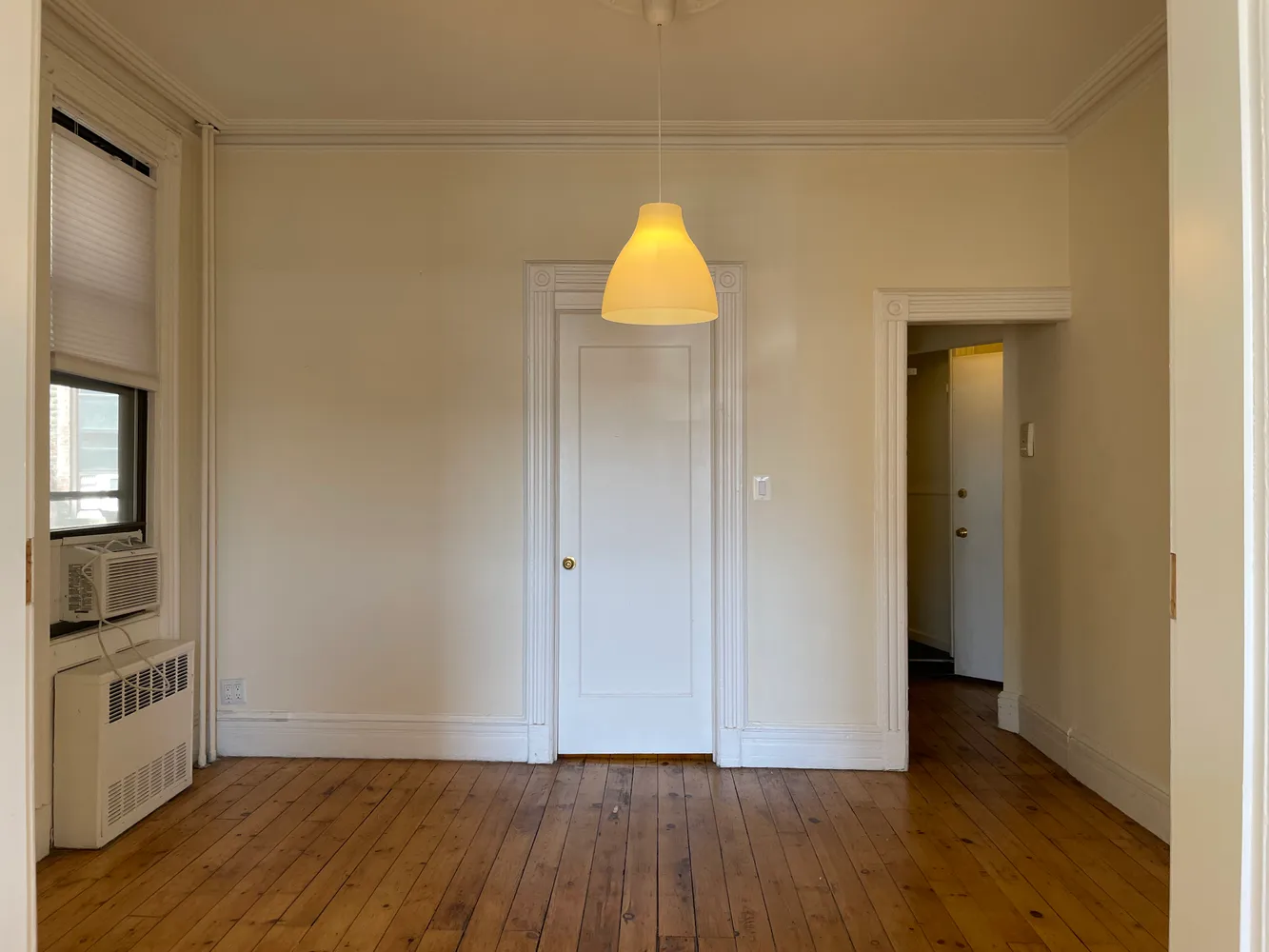 a view of an empty room and wooden floor