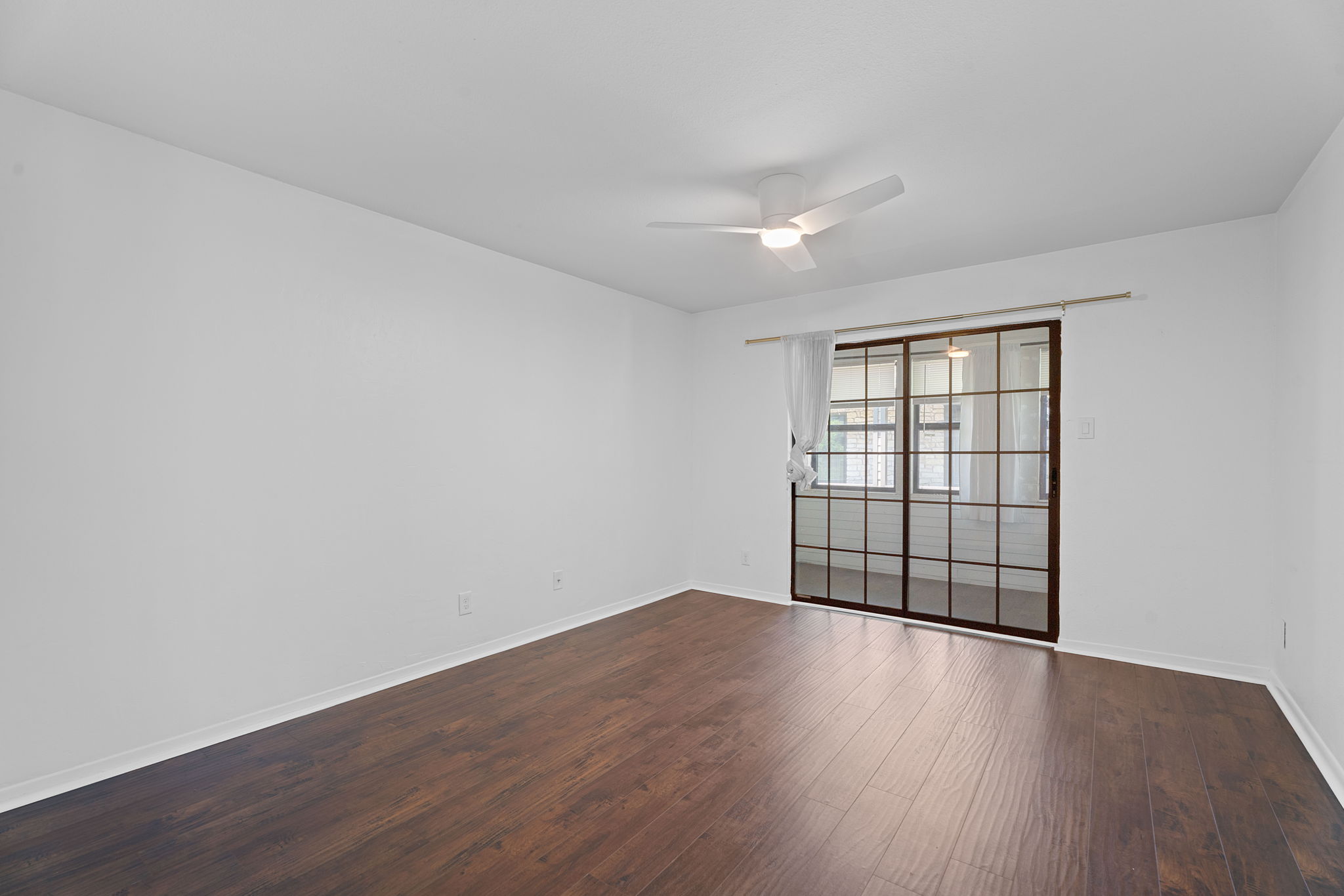 1510 West N Loop Boulevard, Unit 424 Austin, TX 78756 - Photo 14 of 25 a view of wooden floor in an empty room with a window