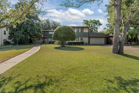 a view of a swimming pool with a patio and a yard