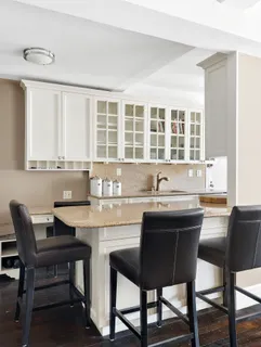 a kitchen with a dining table chairs and window