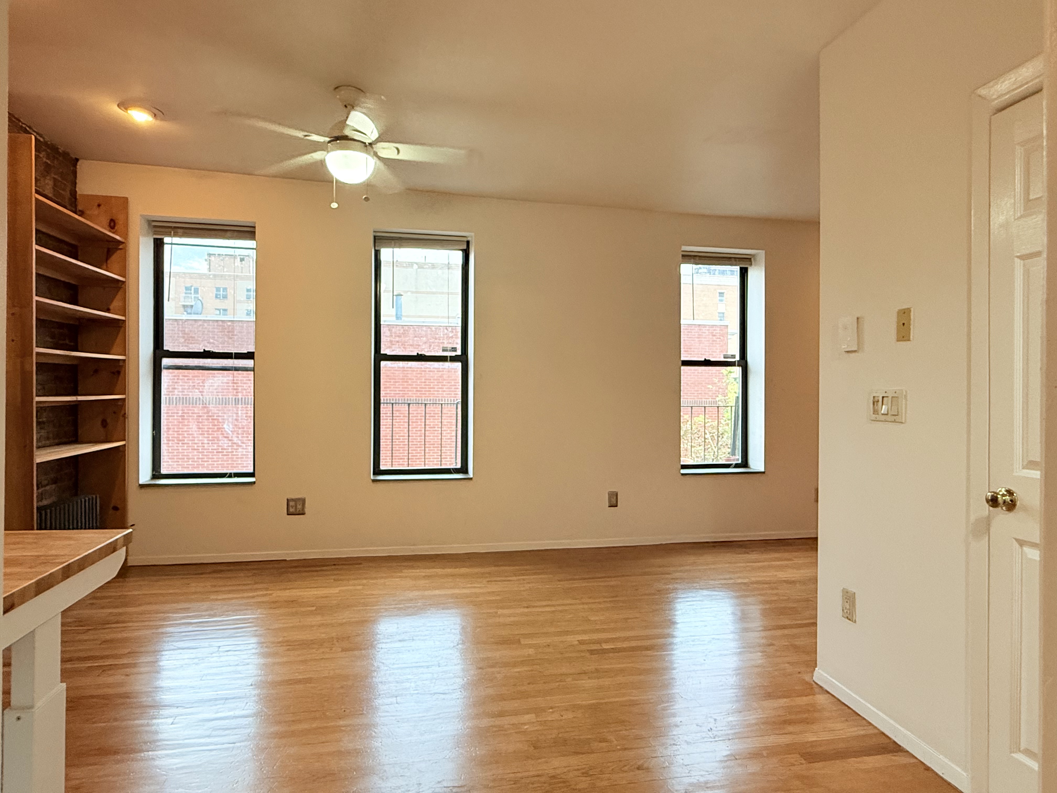 1672 Park Avenue, Unit 4A Manhattan, NY 10035 - Photo 6 of 11 an empty room with wooden floor and windows