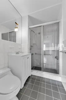 a bathroom with a toilet sink and a mirror