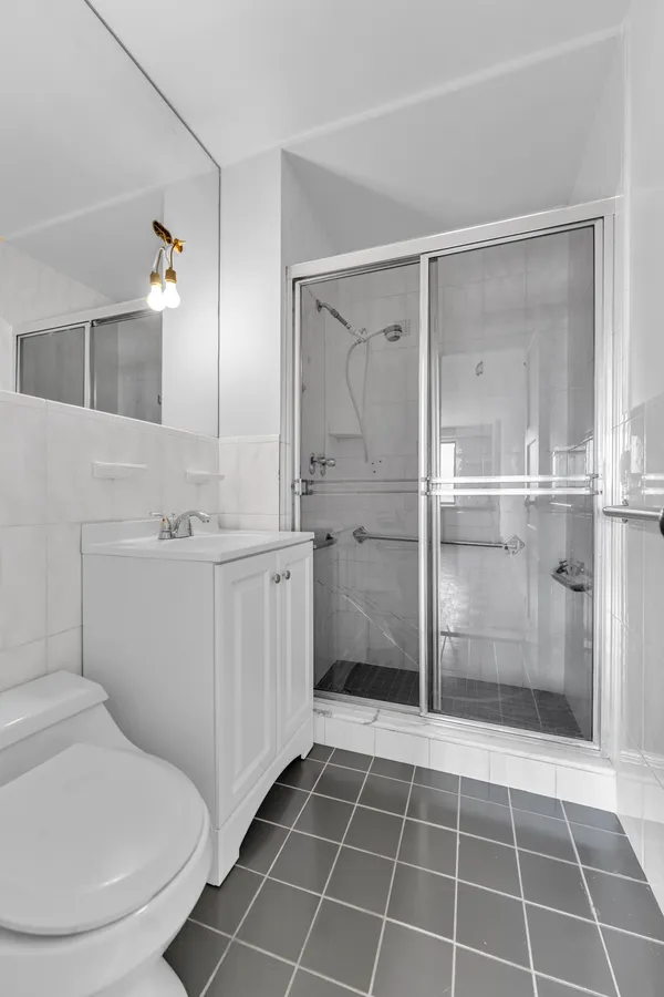 a bathroom with a toilet sink and a mirror