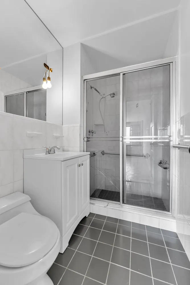 a bathroom with a toilet sink and a mirror