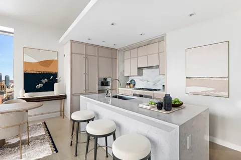 a kitchen with a sink cabinets and dining table chair