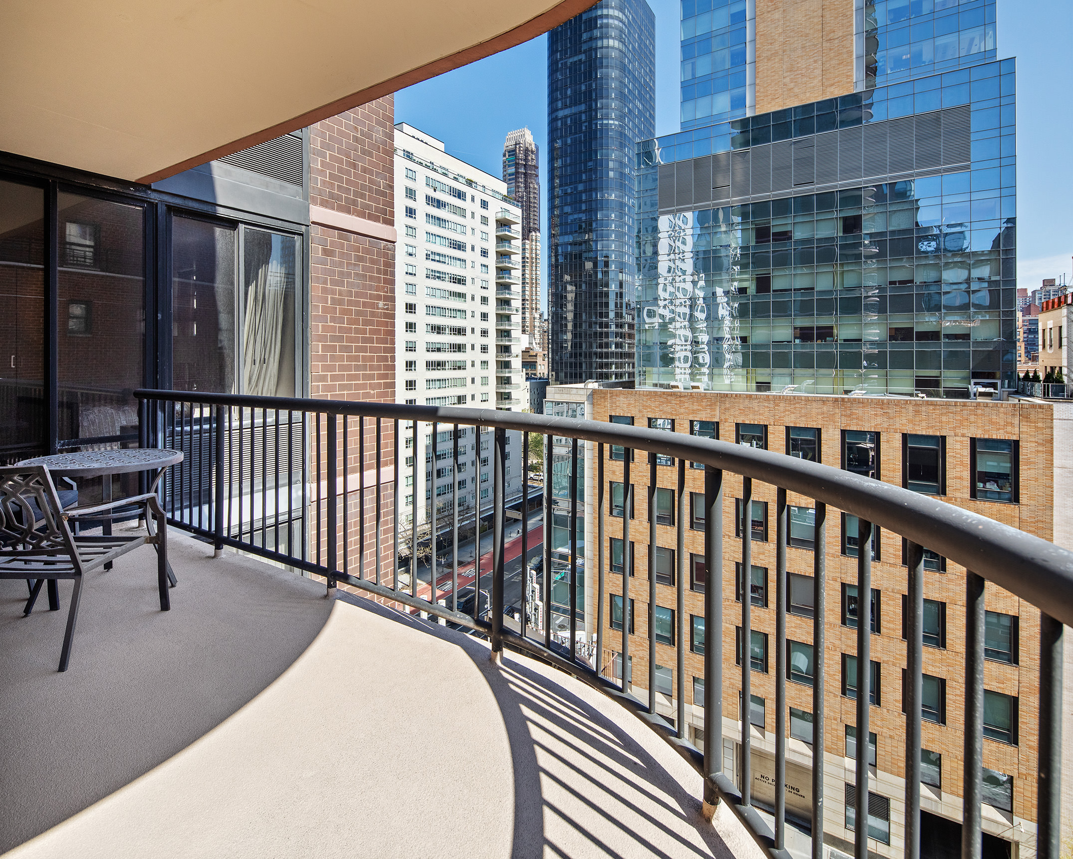 304 East 65th Street, Unit 10D Manhattan, NY 10065 - Photo 10 of 14 a view of a balcony with a couple of chairs