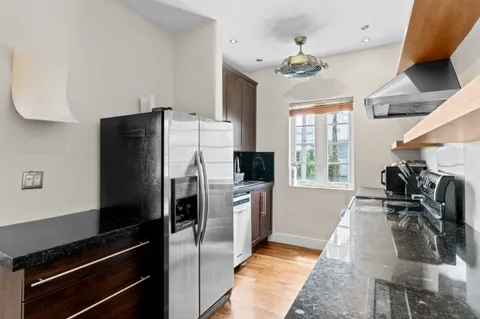 a kitchen with a refrigerator and a stove
