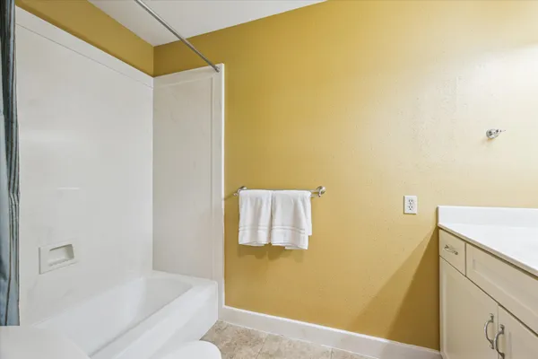 a bathroom with a bathtub and shower