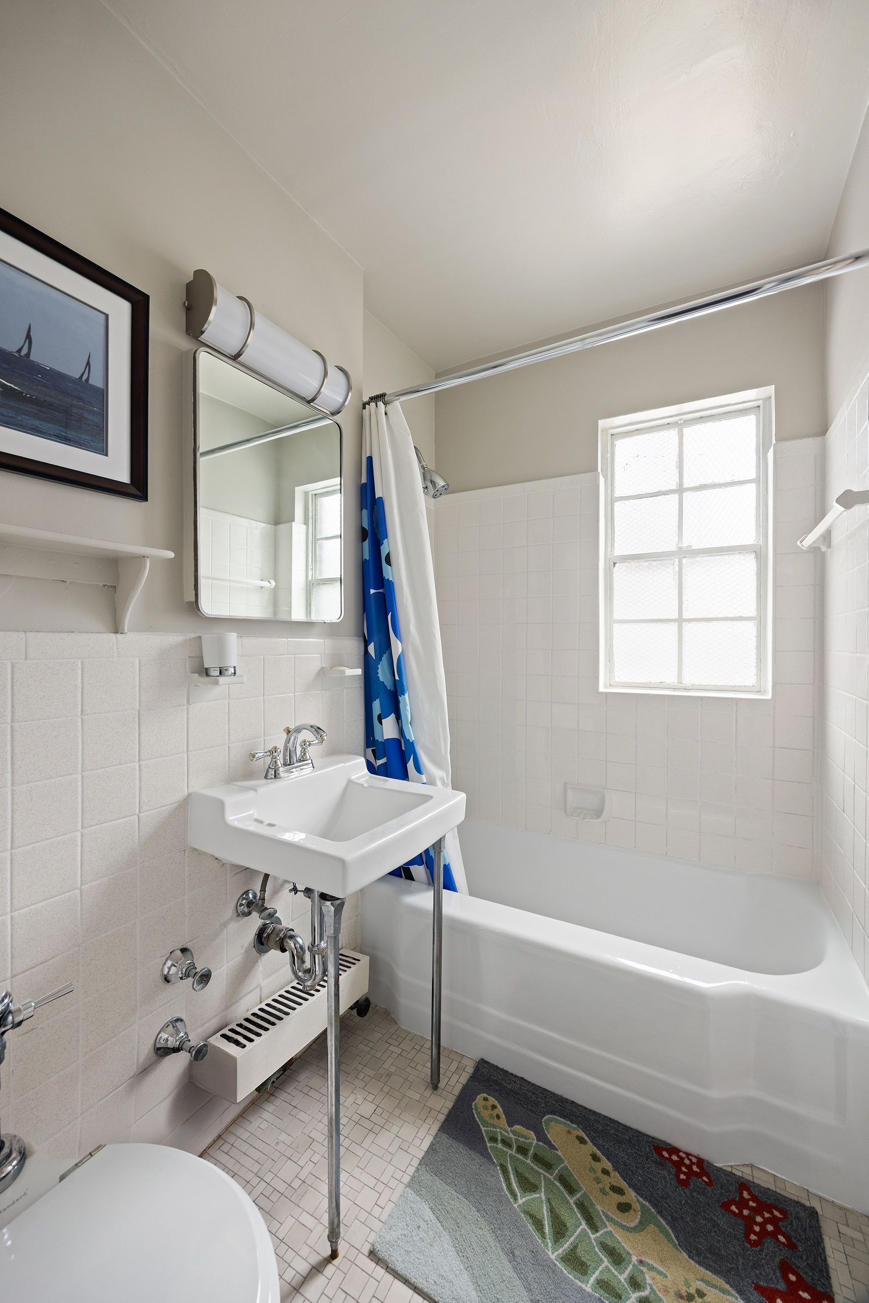 205 East 77th Street, Unit 11B Manhattan, NY 10075 - Photo 7 of 11 a bathroom with a sink and a mirror