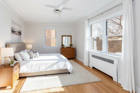 a bathroom with a sink a toilet and window