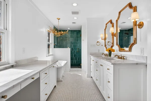 a spacious bathroom with a granite countertop sink and a mirror