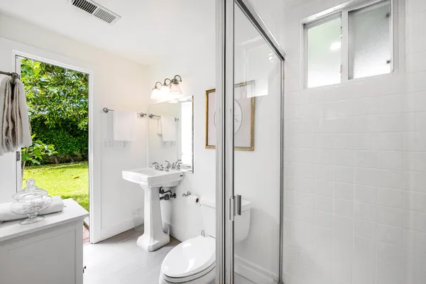 a bathroom with a sink a toilet and a shower