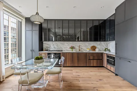 a kitchen with granite countertop a stove a sink and a refrigerator