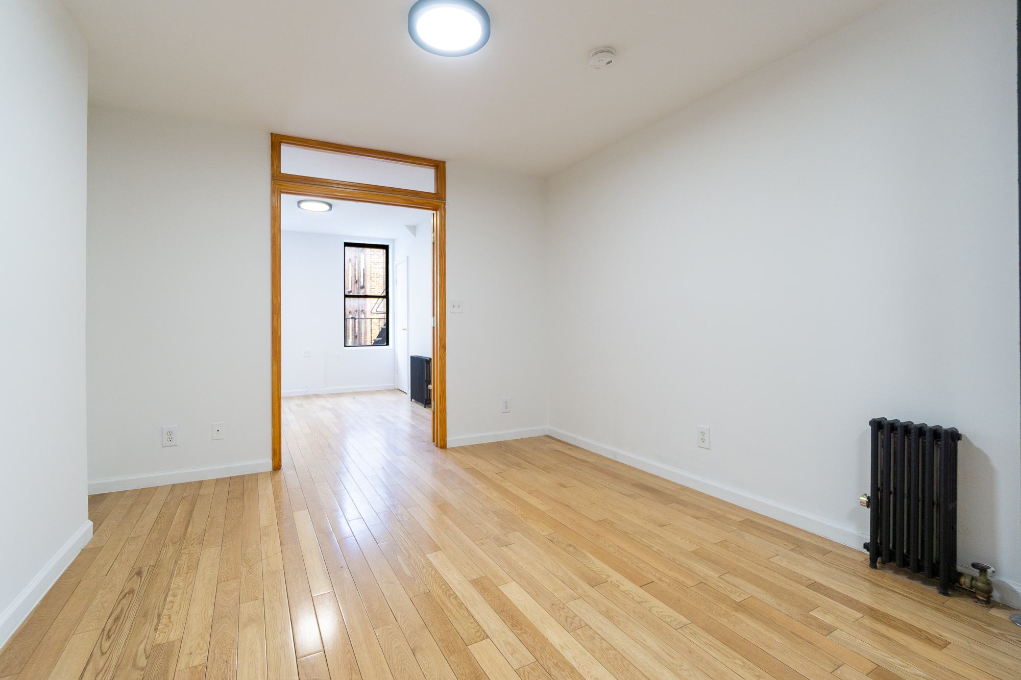 337 East 6th Street, Unit 9 Manhattan, NY 10003 - Photo 6 of 15 a view of a room with wooden floor