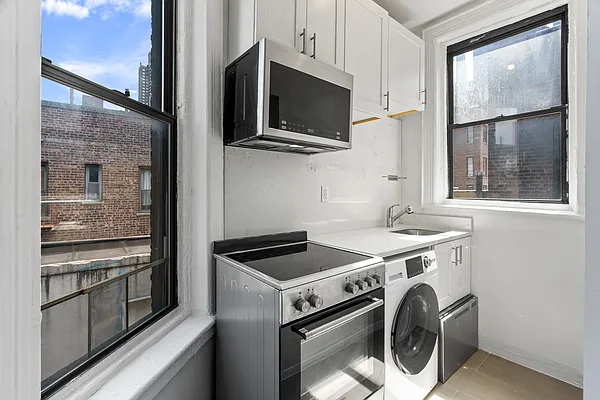 824 9th Avenue, Unit 5RN Manhattan, NY 10019 - Photo 8 of 11 a kitchen with a stove and a microwave