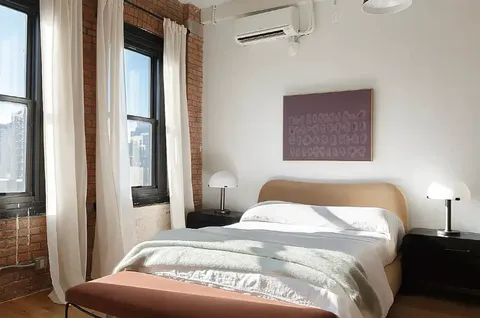 a bedroom with a bed and a night stand