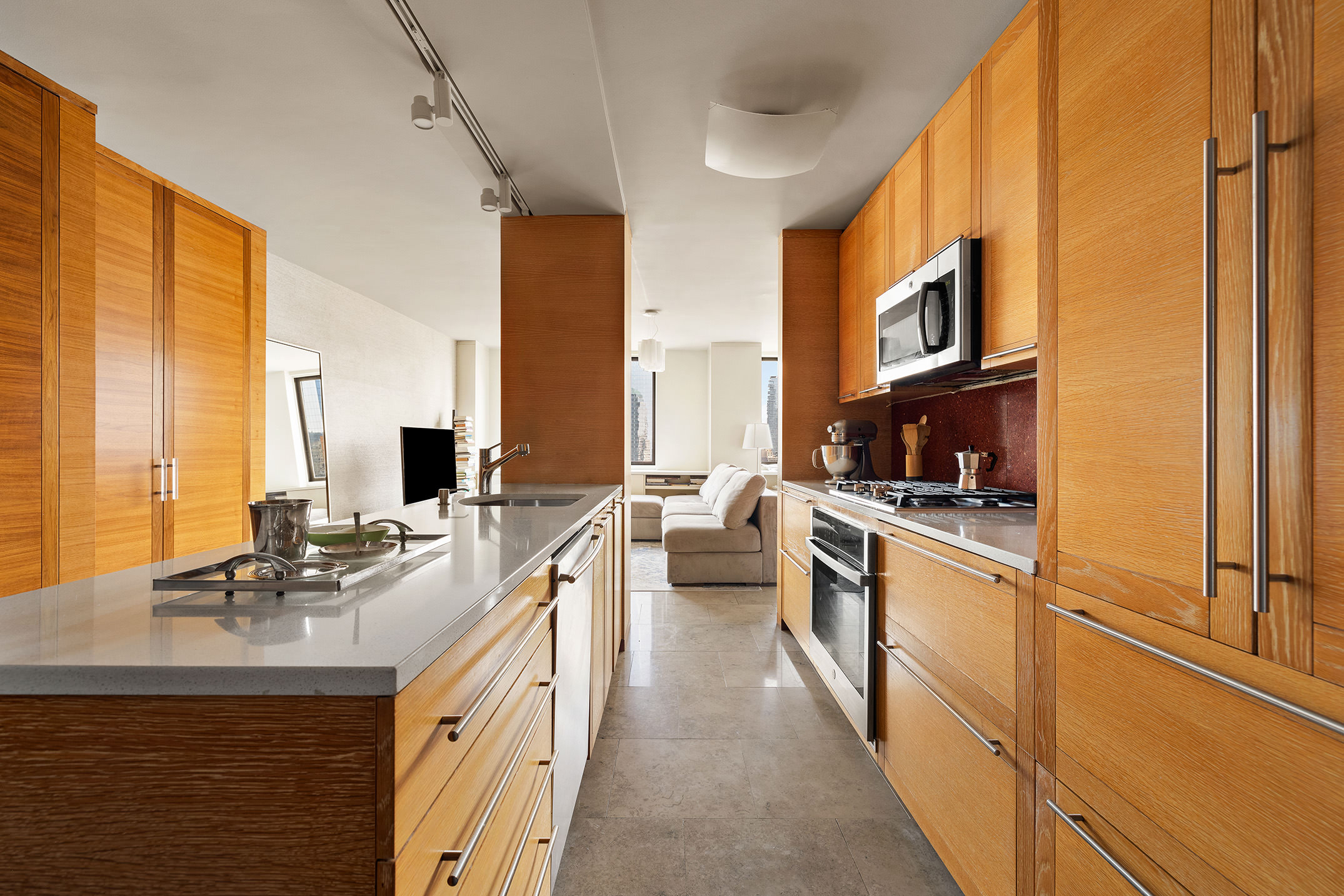 200 Rector Place, Unit 36LM Manhattan, NY 10280 - Photo 6 of 15 a large kitchen with stainless steel appliances a sink and cabinets