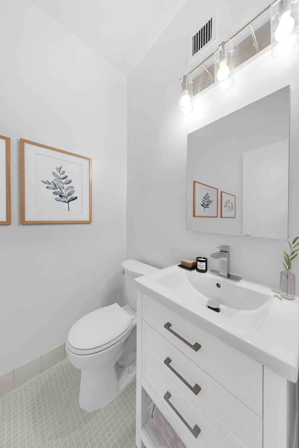 58 West 58th Street, Unit 21C Manhattan, NY 10019 - Photo 6 of 12 a bathroom with a toilet a sink and mirror