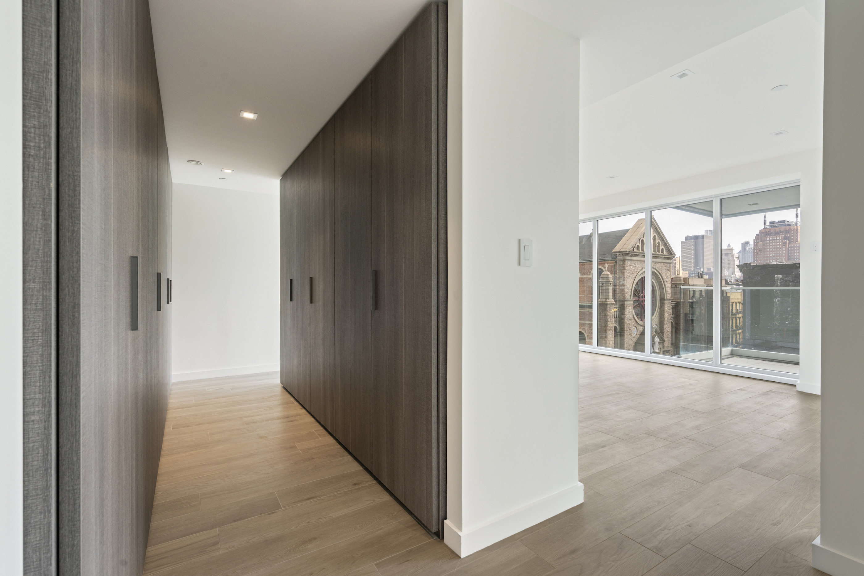 136 West Houston Street, Unit 6 Manhattan, NY 10012 - Photo 4 of 14 a view of a big room with wooden floor and windows