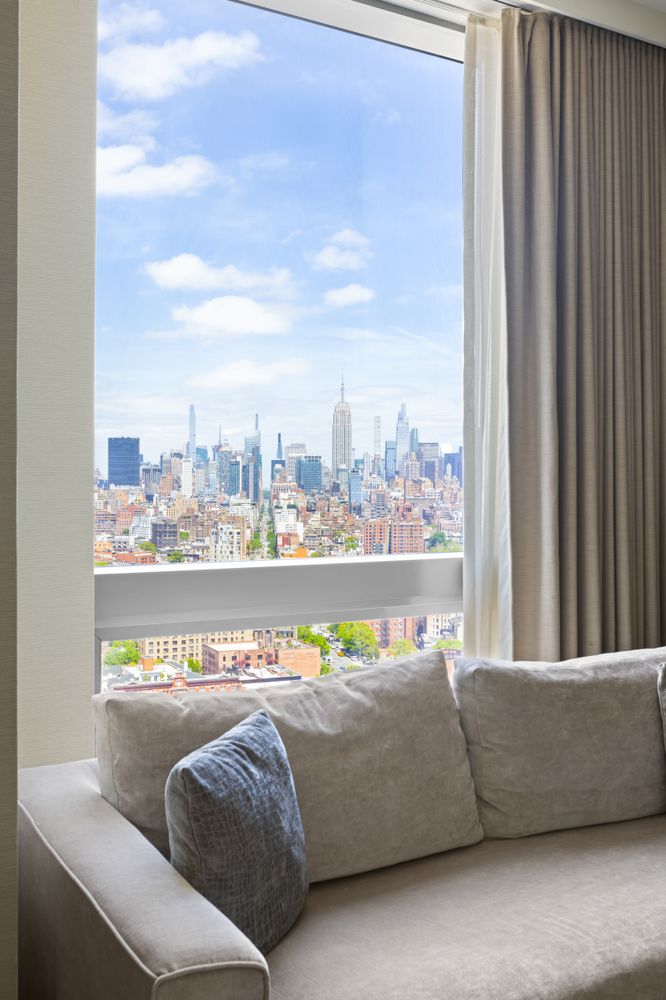 246 Spring Street, Unit 2910 Manhattan, NY 10013 - Photo 3 of 17 a living room with furniture and a large window