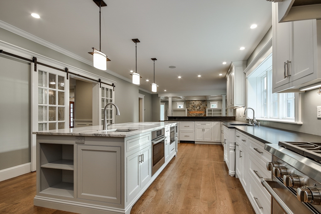 185 Dedham Street Dover, MA 02030 - Photo 7 of 32 a large kitchen with stainless steel appliances kitchen island a large counter tops a stove a sink and a refrigerator