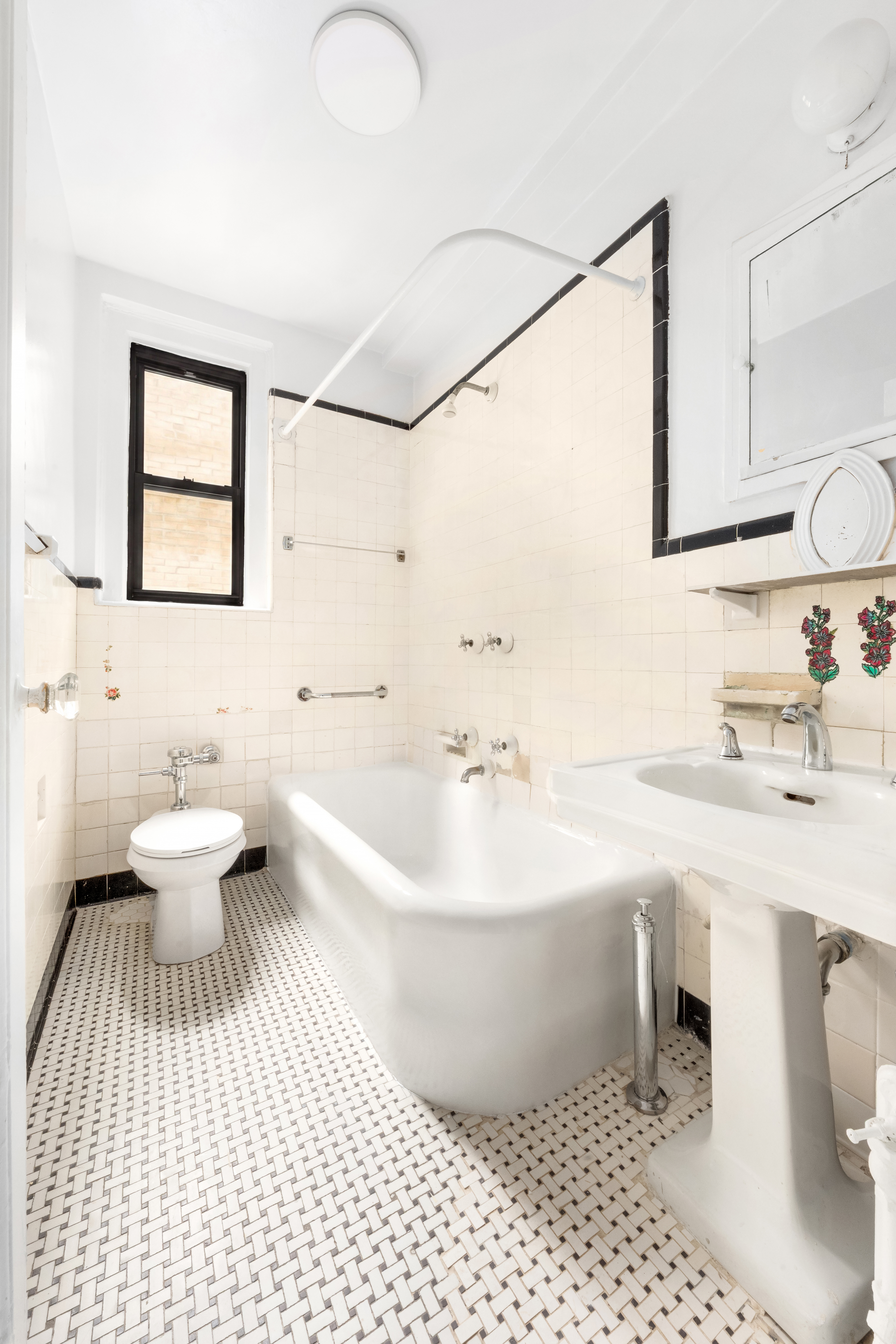 170 2nd Avenue, Unit 3E Manhattan, NY 10003 - Photo 7 of 12 a bathroom with a sink a toilet and a mirror