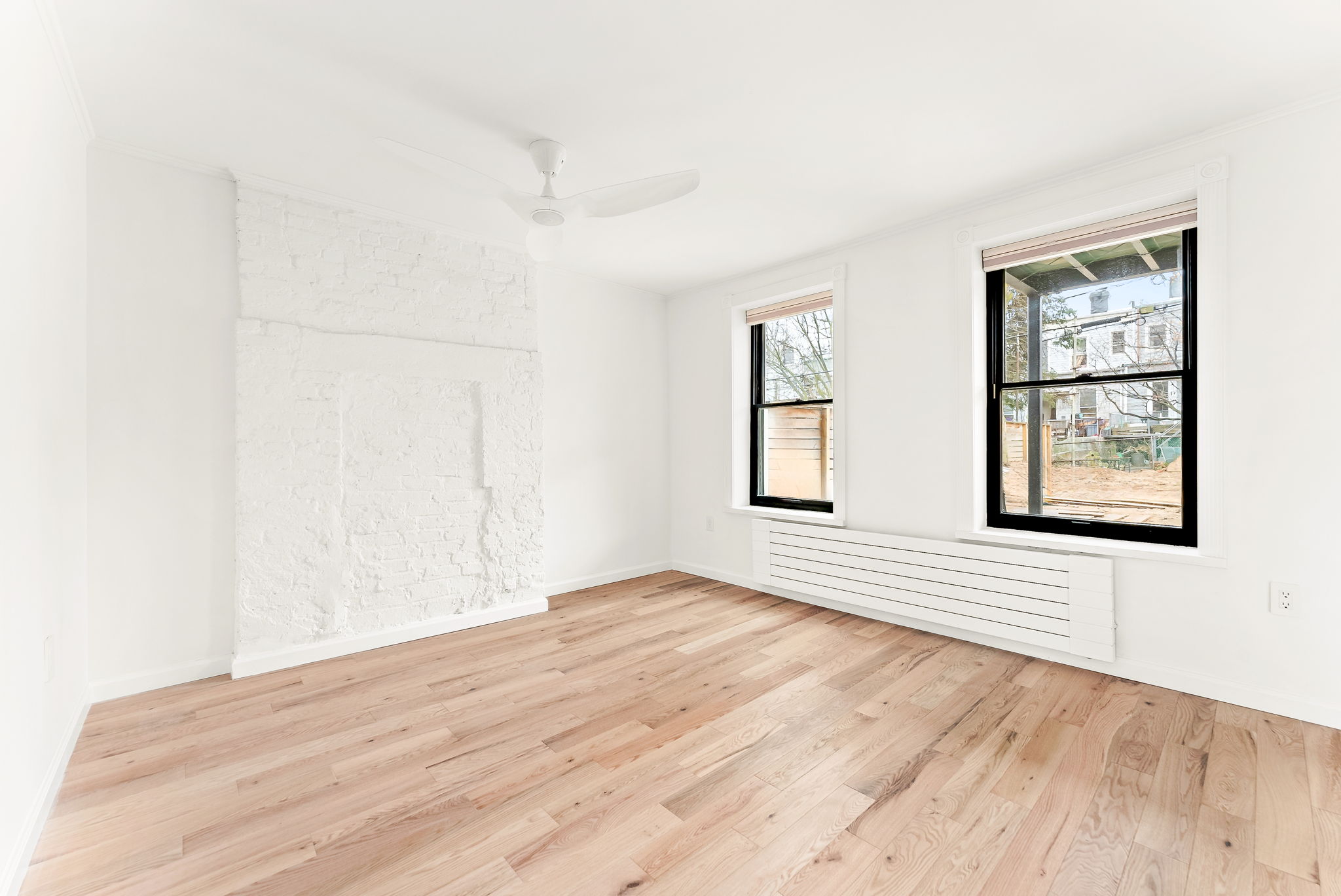 54 East 4th Street, Unit 1 Brooklyn, NY 11218 - Photo 2 of 12 an empty room with wooden floor and windows