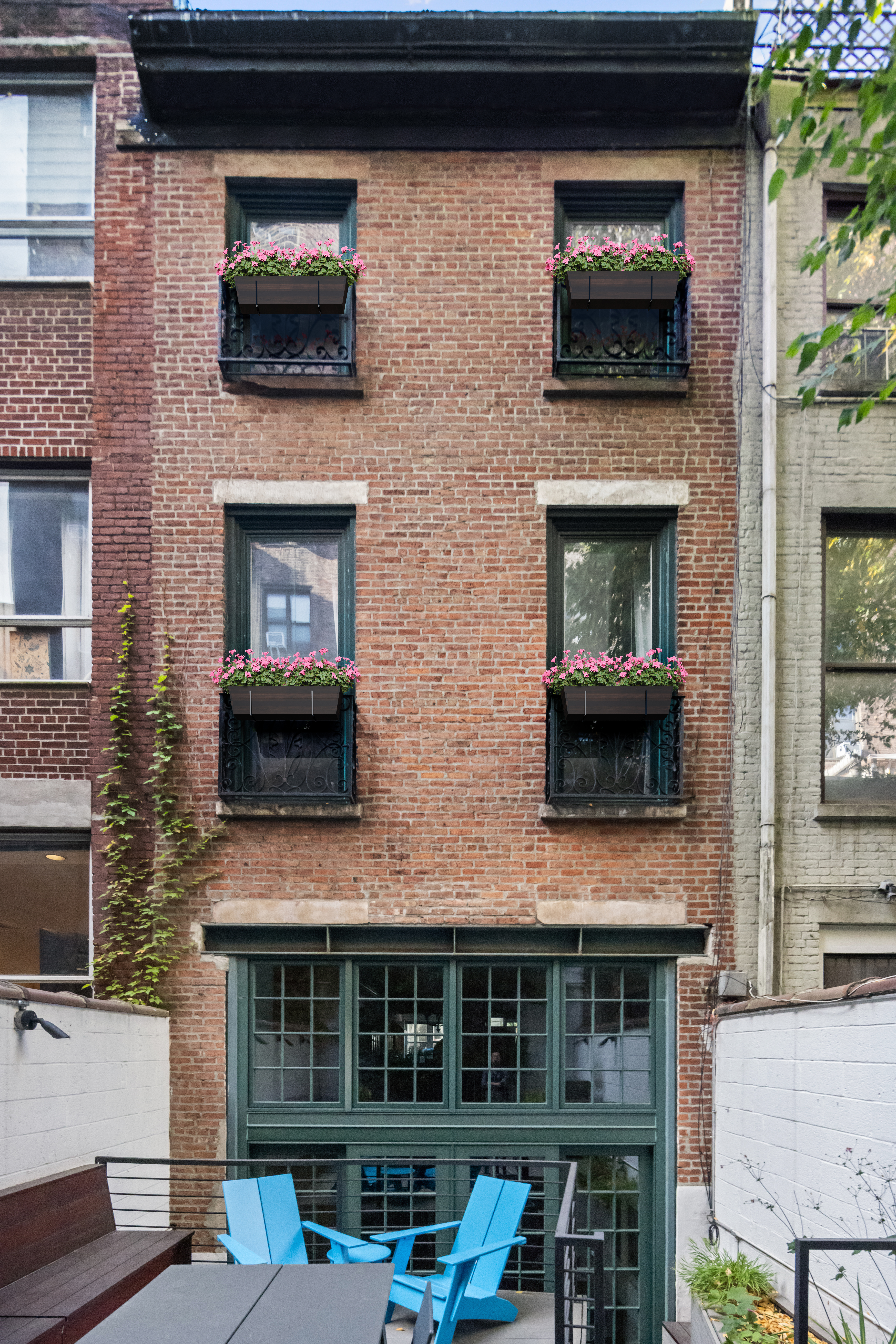 217 West 22nd Street Manhattan, NY 10011 - Photo 5 of 16 a front view of a house with a yard
