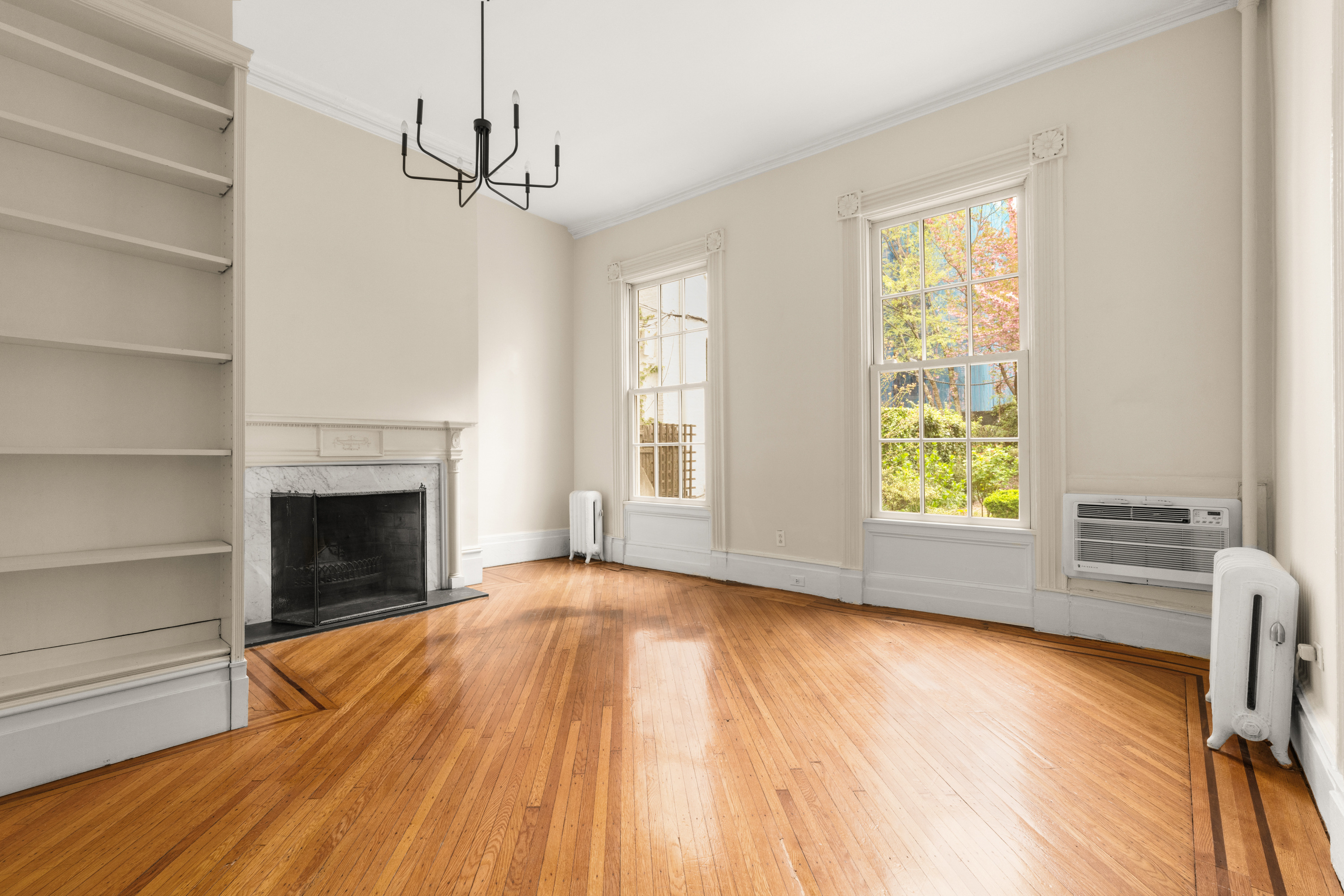 60 Hicks Street Brooklyn, NY 11201 - Photo 4 of 22 a view of empty room with wooden floor and fireplace