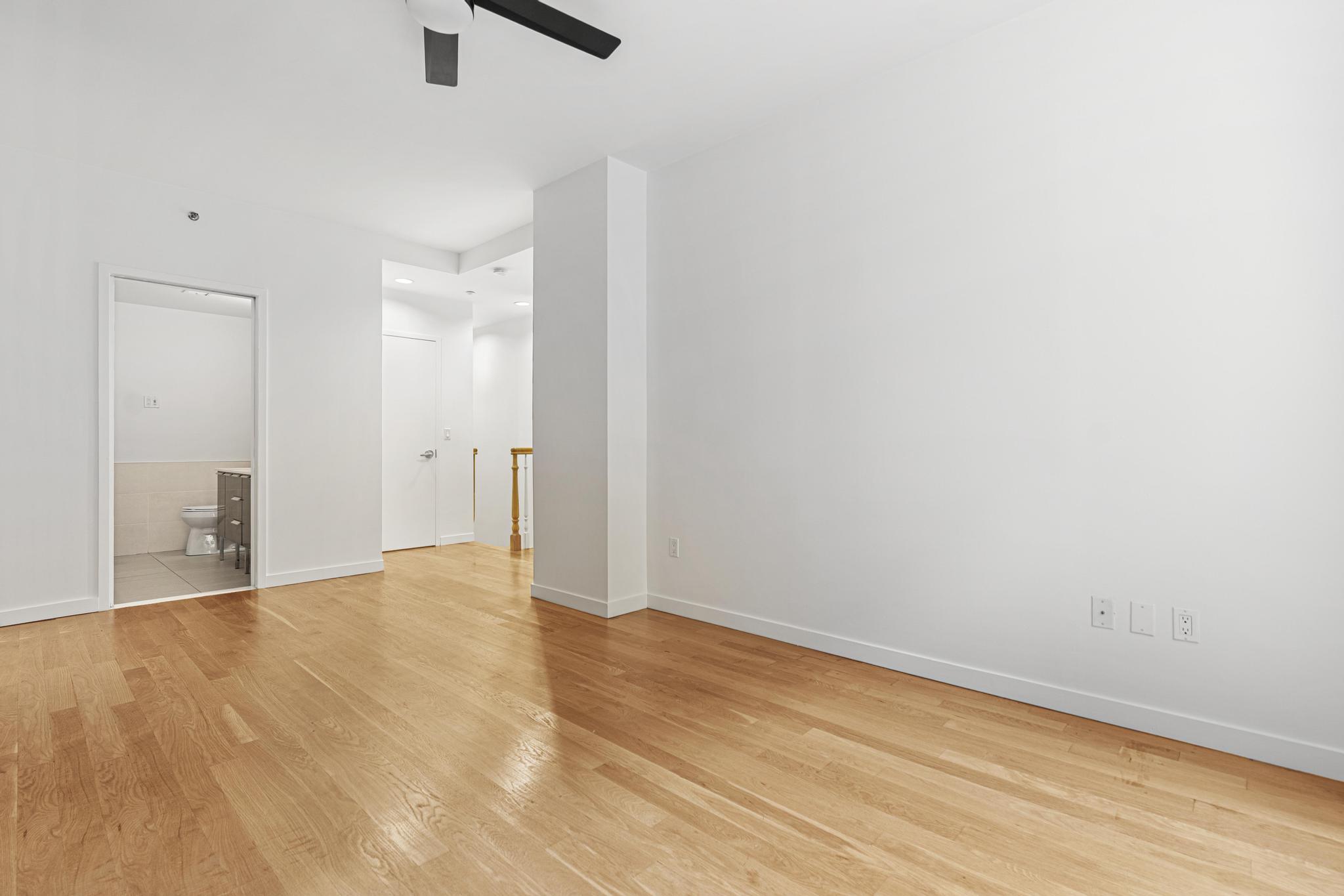 306 West 116th Street, Unit 1C Manhattan, NY 10026 - Photo 8 of 12 a view of empty room with wooden floor