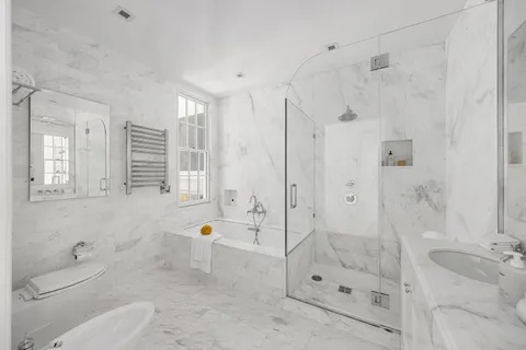 a bathroom with a shower a toilet and a sink