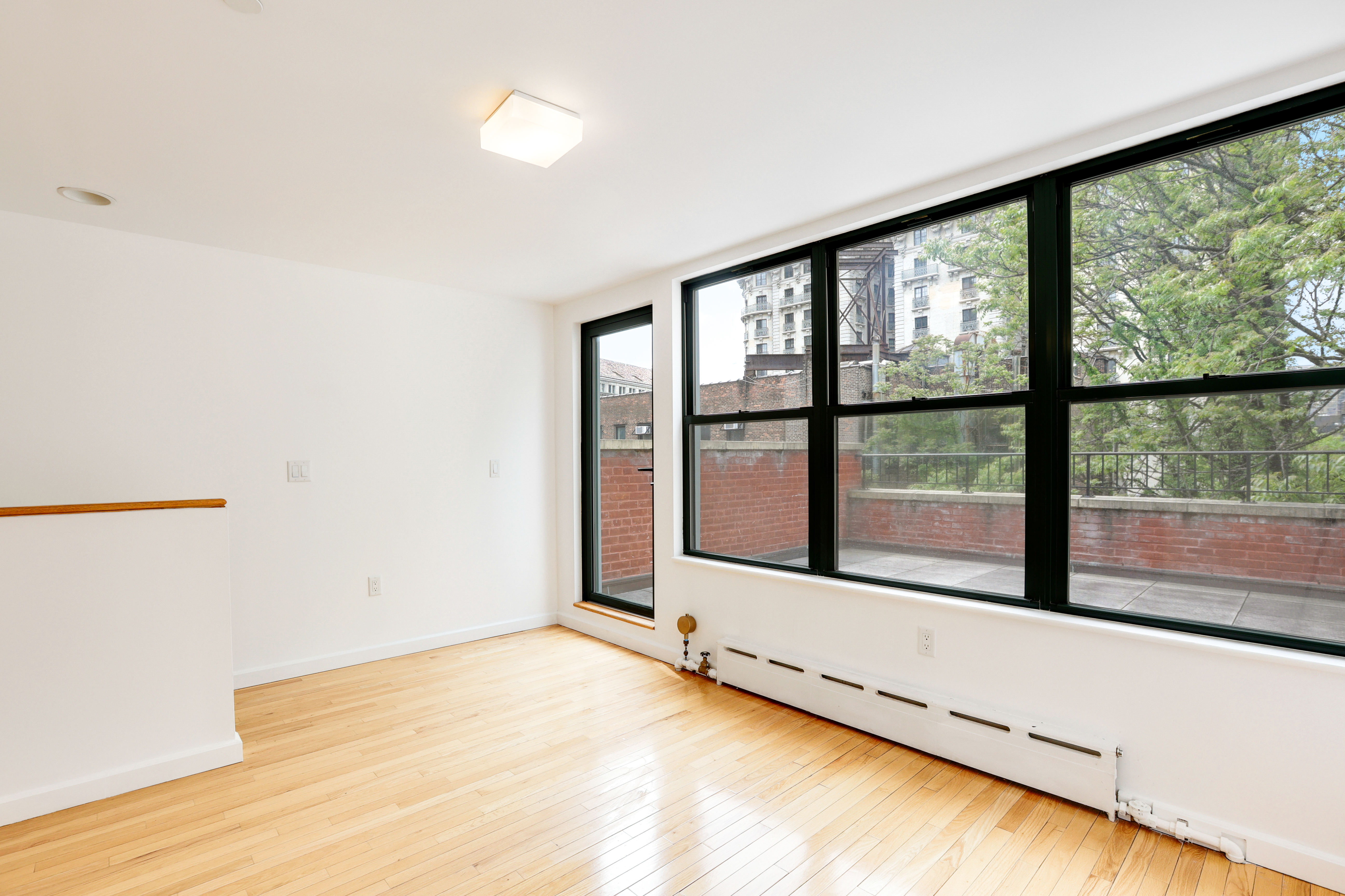 230 West 75th Street, Unit 4 Manhattan, NY 10023 - Photo 12 of 16 a view of an empty room and a window