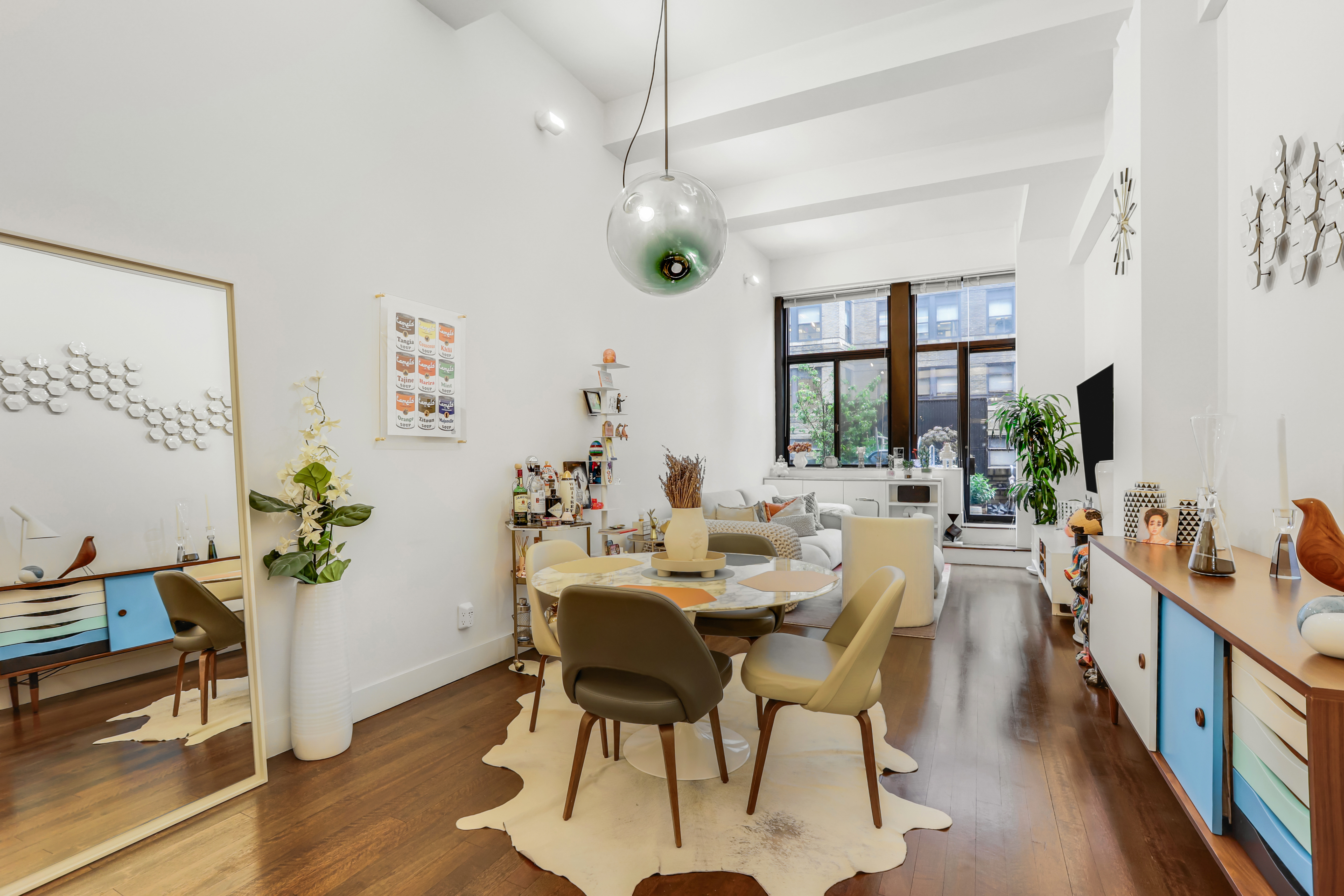 a view of a dining room with furniture window and wooden floor